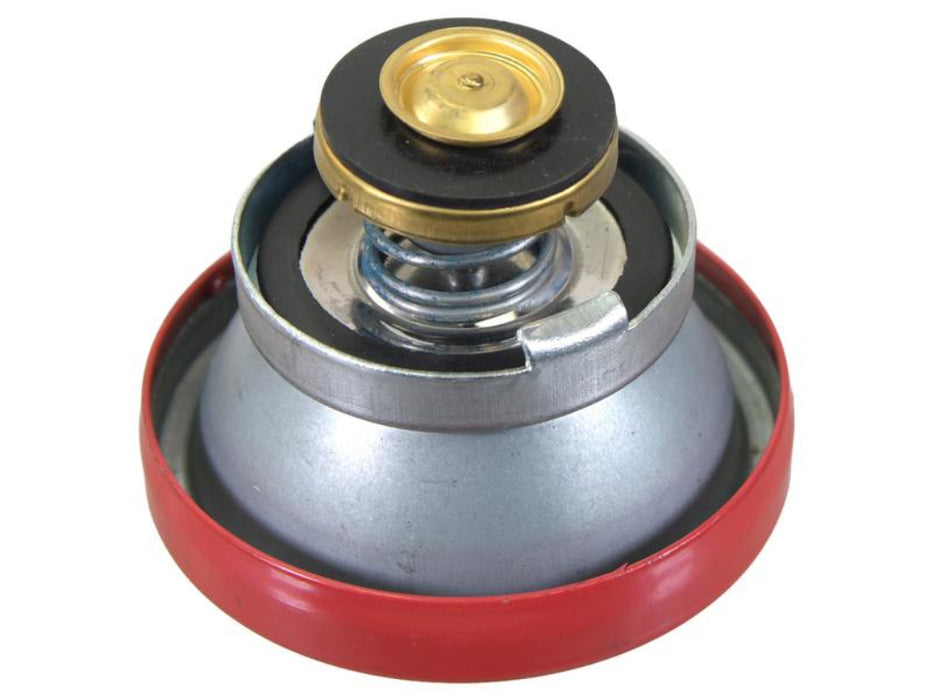 underside of red radiator cap on white back ground