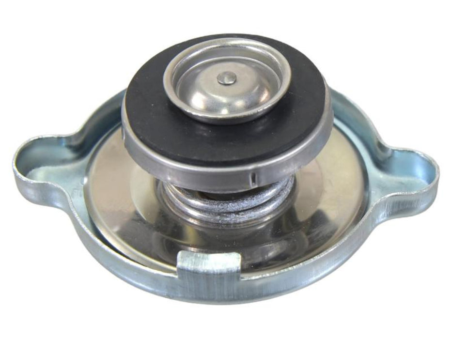 Metal radiator cap with engraved text on a white background upside down