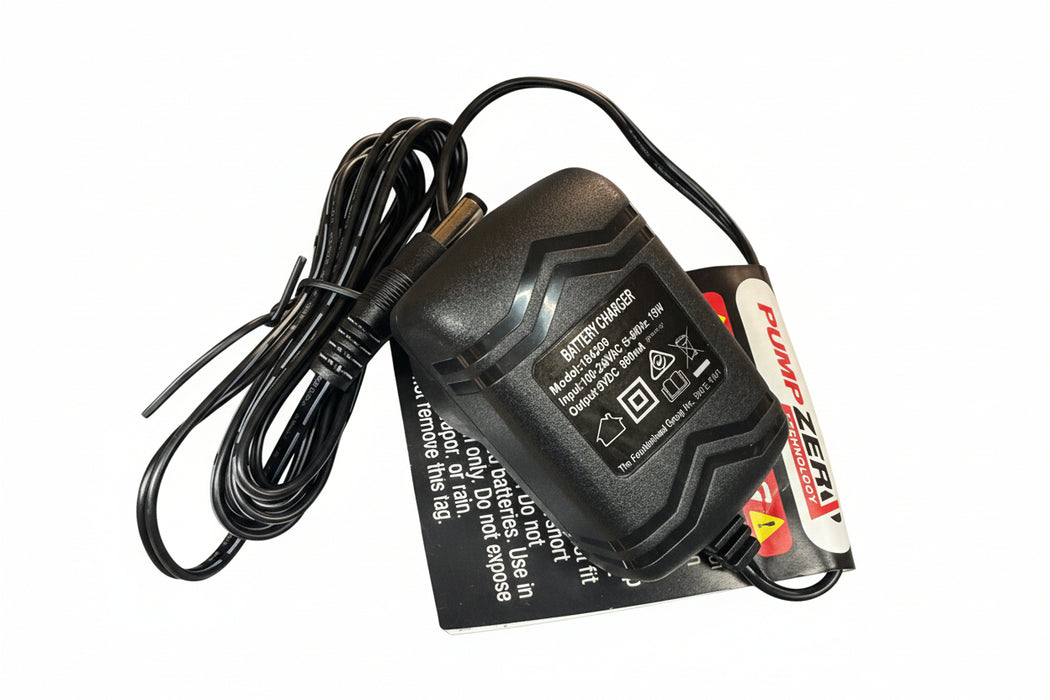 Black battery charger with cable on a metallic surface