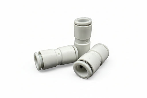 White plastic plumbing fitting on a reflective surface