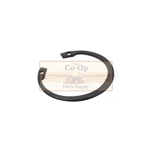 A black metal circular spring clip or gasket with two small mounting holes, shown on a white background with a faint 'The Co-Op Farm Supply' watermark behind it.