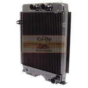 A heavy-duty automotive radiator with a black ribbed finned core and silver metal housing, featuring two black intake tubes on top and a Co-Op Farm Supply watermark overlay.