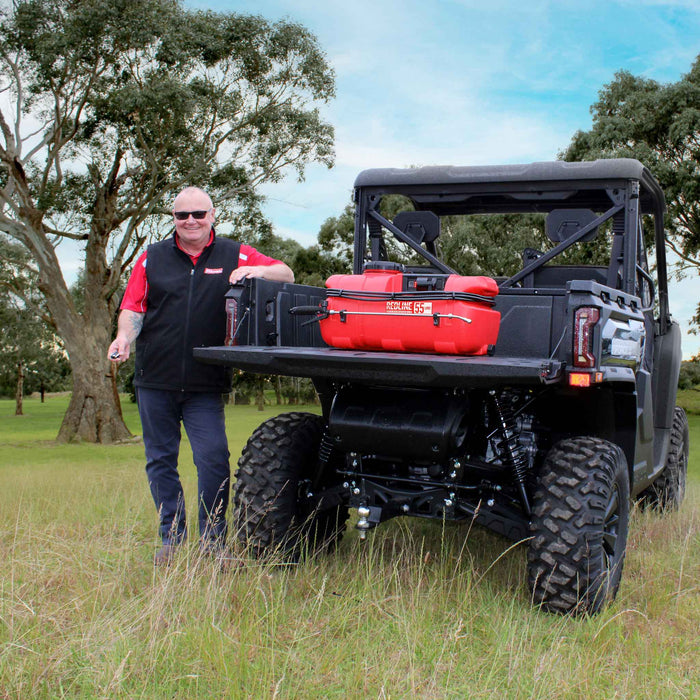 Man standing with Silvan Rechargeable 55L Redline Remote Control Sprayer on UTV