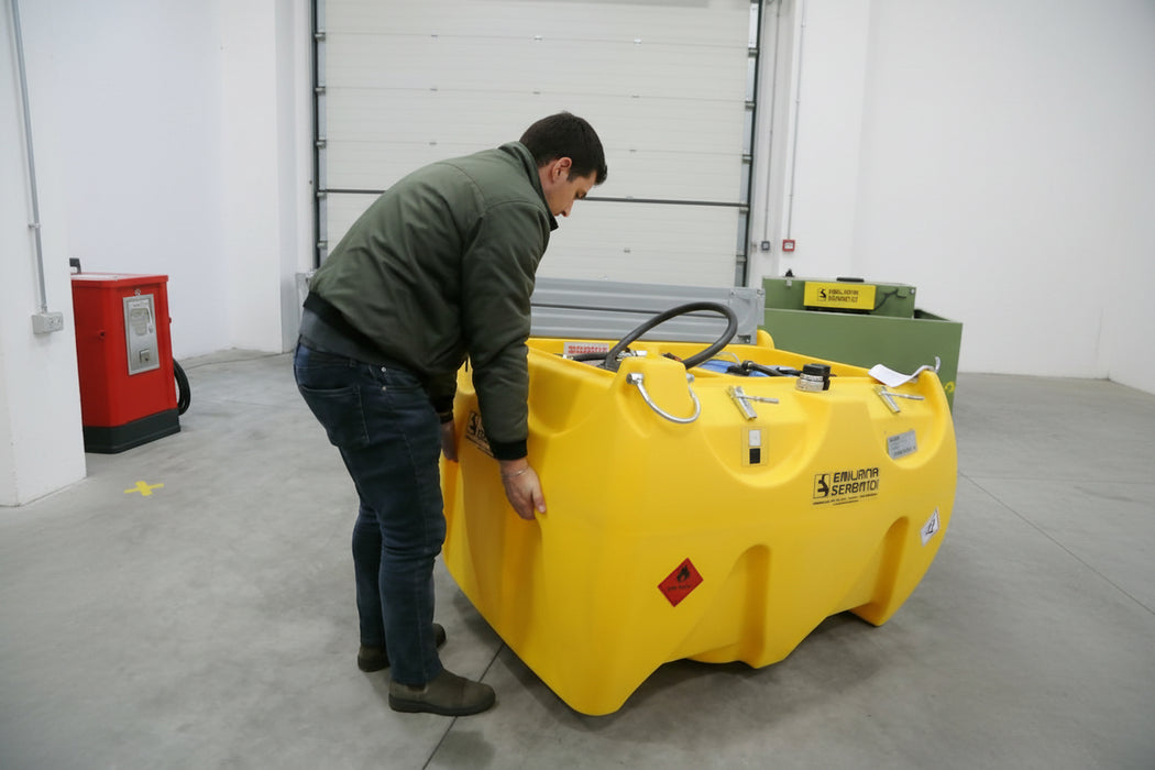 Person interacting with a large yellow container in an indoor setting