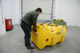 Person interacting with a large yellow container in an indoor setting