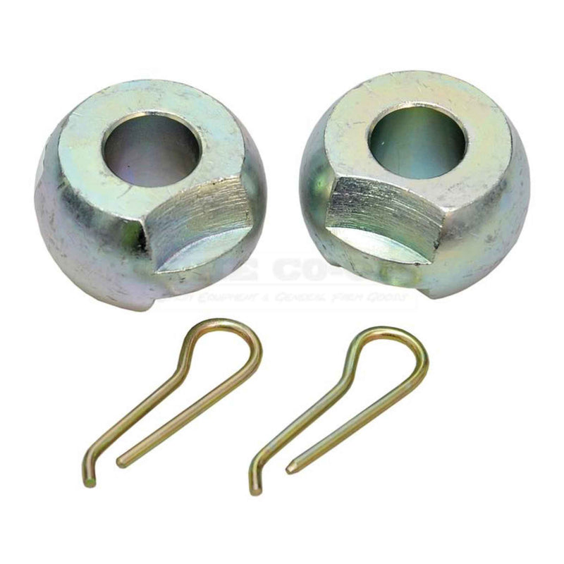 Two metal bushings and two spring clips on a white background